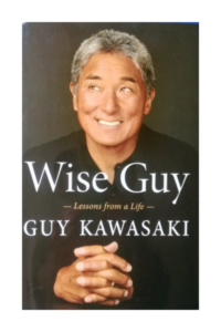 Book cover of 'Wise Guy' by Guy Kawasaki, featuring a portrait of the author in a black shirt, smiling.